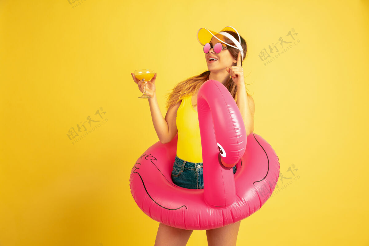 夏天年轻女子在沙滩上摆着鸡尾酒度假村快乐工作