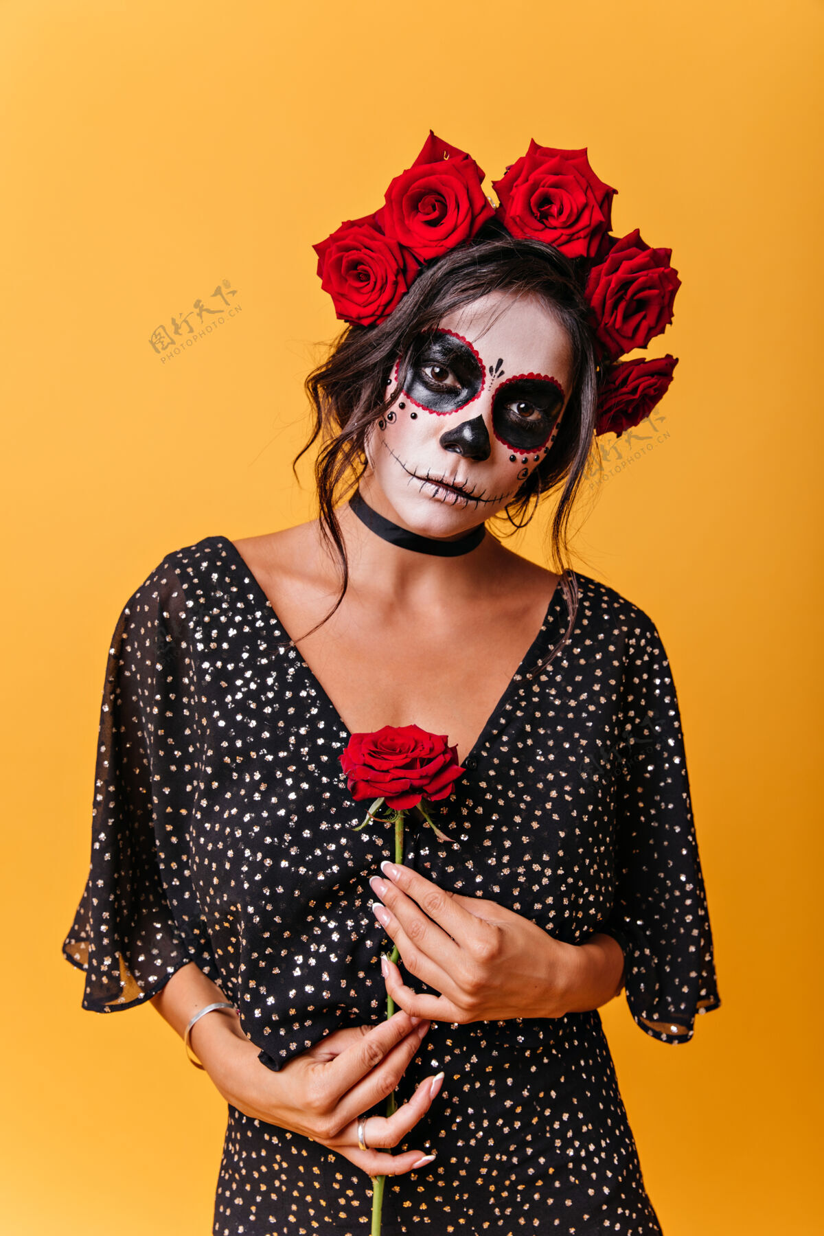 黑发浪漫的墨西哥人轻轻地捧着玫瑰神秘女人的肖像 头发上戴着鲜花 万圣节化妆女巫人物花