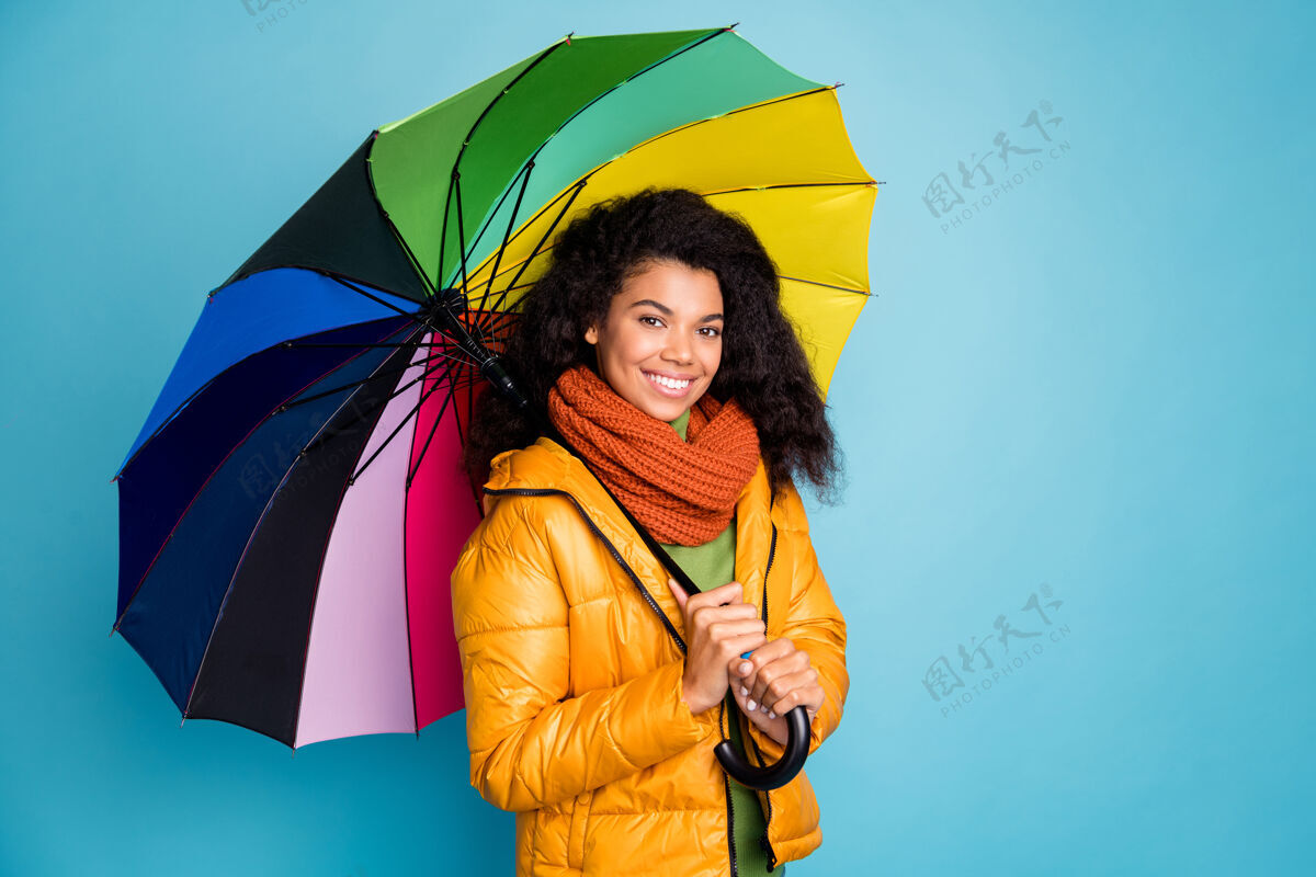 蓝色背景美丽的深色皮肤的女士在蓝色背景下带着雨伞的照片雨伞多民族皮肤
