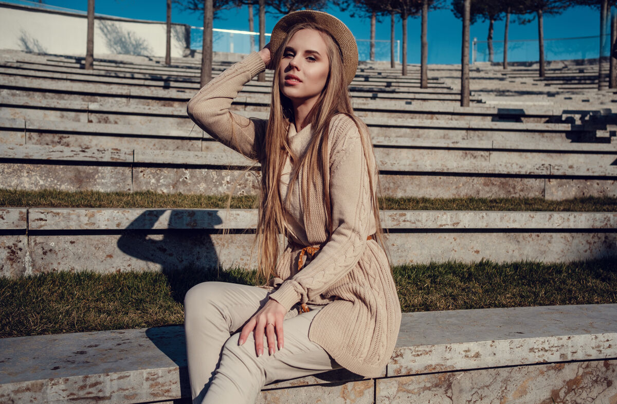 模特一个年轻漂亮的女人在阳光明媚的冬季公园散步皮草金发孤独