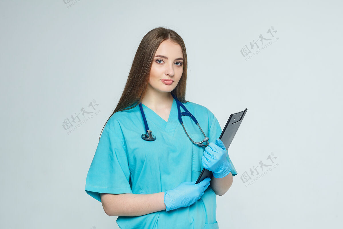 专业一个医生的画像 剪贴板和听诊器被隔离在白色的墙上制服护理医学