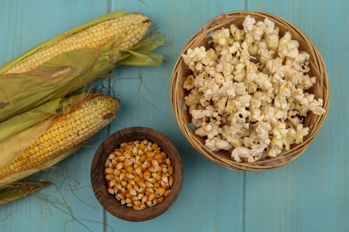 玉米有机健康玉米的俯视图 蓝色木桌上的木盆上放着玉米粒 桶上放着爆米花爆米花有机视野