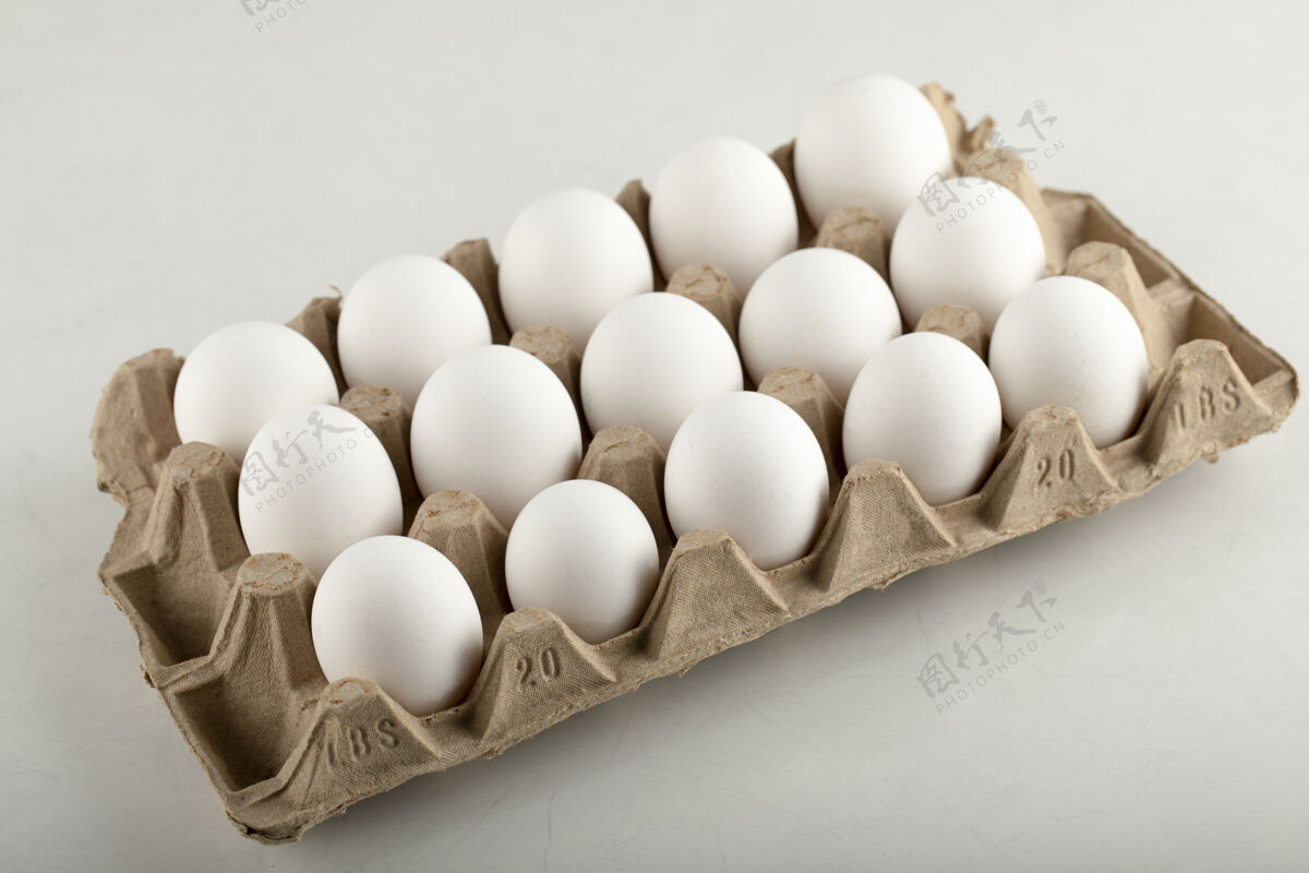 蛋白质生鸡蛋放在蛋盒里 放在白色的表面上桌面烹饪有机食品