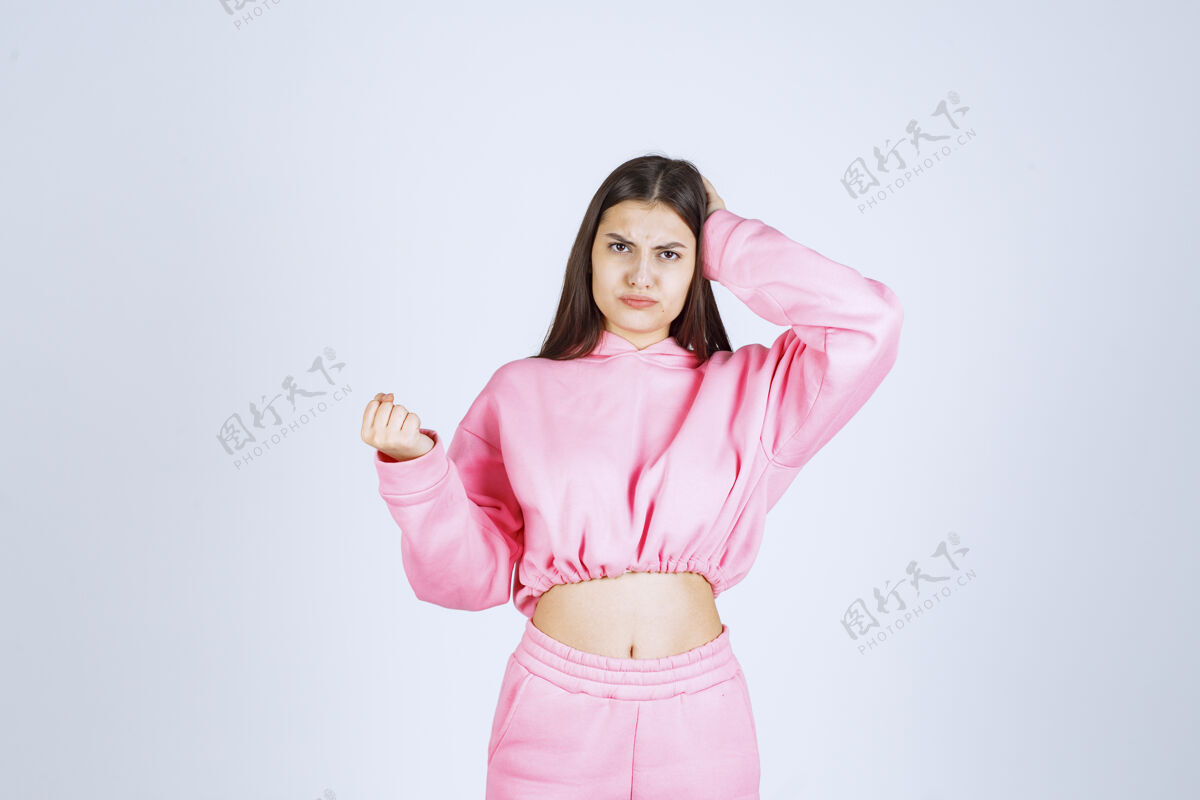 头脑风暴穿粉红色睡衣的女孩看起来很困惑 很体贴女人无聊人