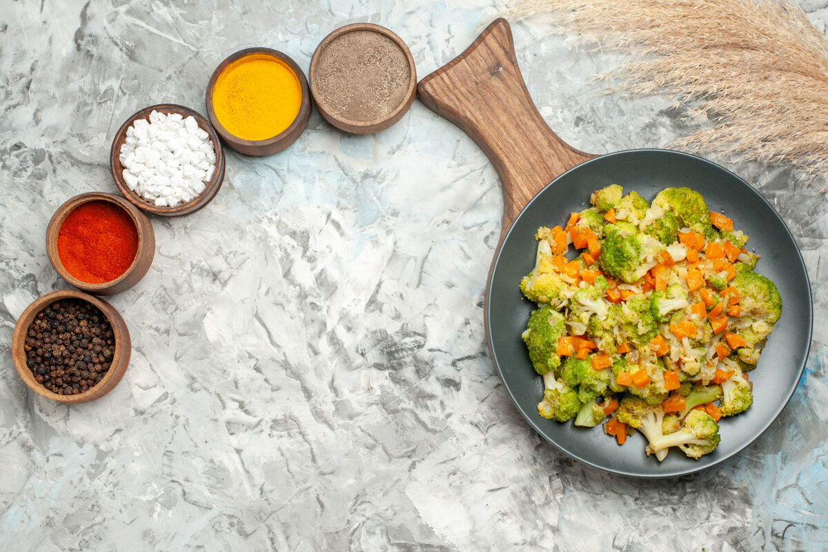 锅健康蔬菜沙拉的水平视图白色桌子上的不同香料食物饮食午餐