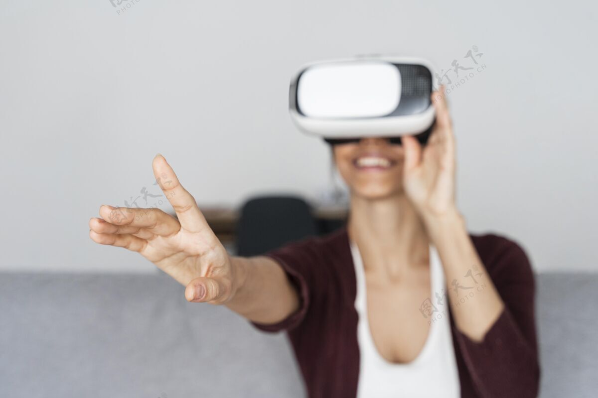 女人笑脸女人用虚拟现实耳机在家里玩得开心虚拟现实享受女人