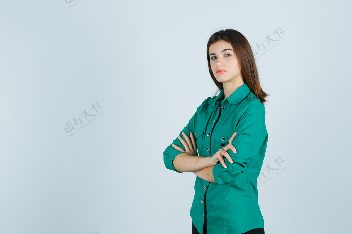 衬衫身着绿色衬衫的美丽年轻女士双臂交叉 表情严肃 正面照表情秋天孤独