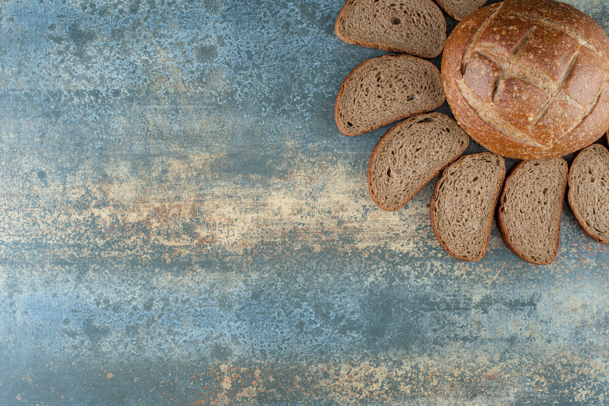 切片一个新鲜的棕色面包片大理石背景面包房糕点食品
