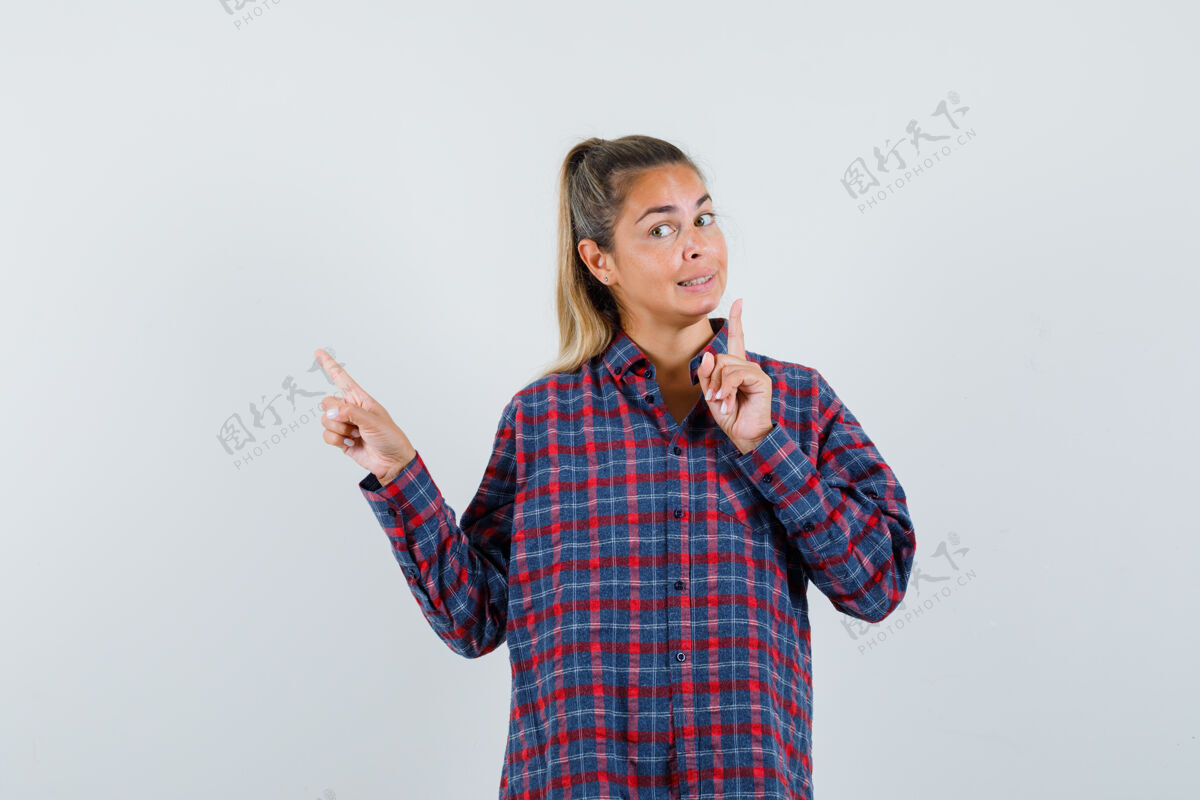 衬衫穿着格子衬衫的年轻女子用食指指着我 看上去很高兴模型手指干净