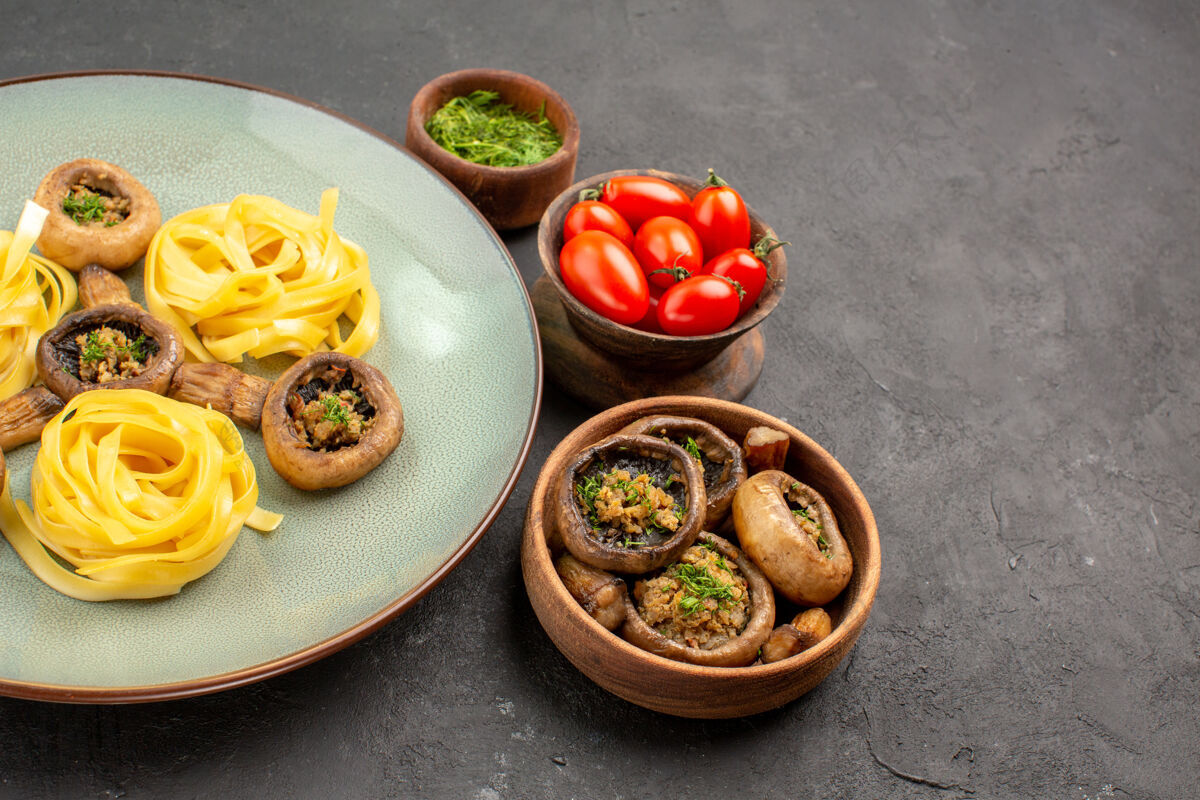 面食前视图煮熟的蘑菇和面团面食在一张深色的餐桌上美食深色蔬菜