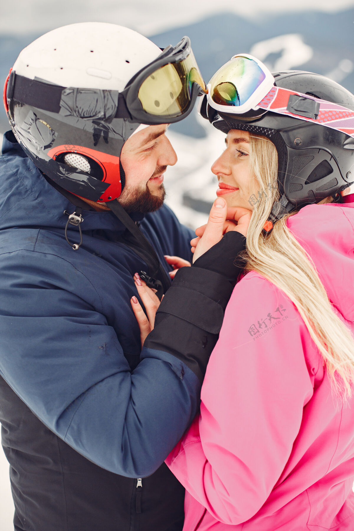 情侣一对穿着运动服的情侣人们在山上度过寒假女人男性拥抱
