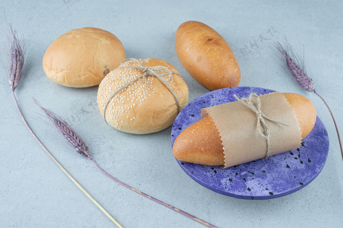 绳索新鲜面包卷和面包放在石头表面面包房有机馒头