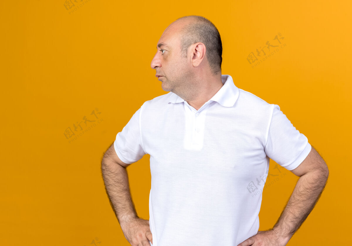 背景看着身边随意的成熟男人把双手放在臀部隔离在黄色的背上休闲手成熟