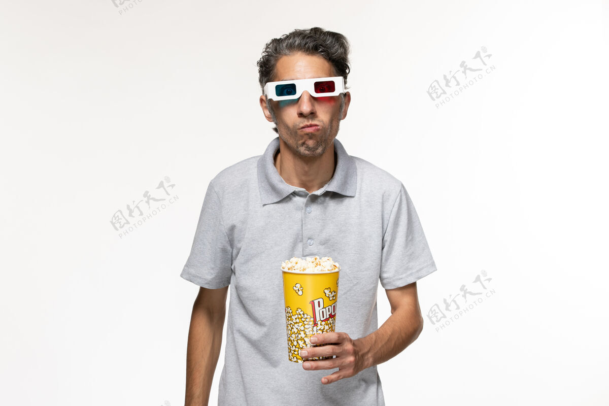 衬衫正面图年轻男性戴着d型太阳镜在白色表面吃爆米花护目镜远程太阳镜