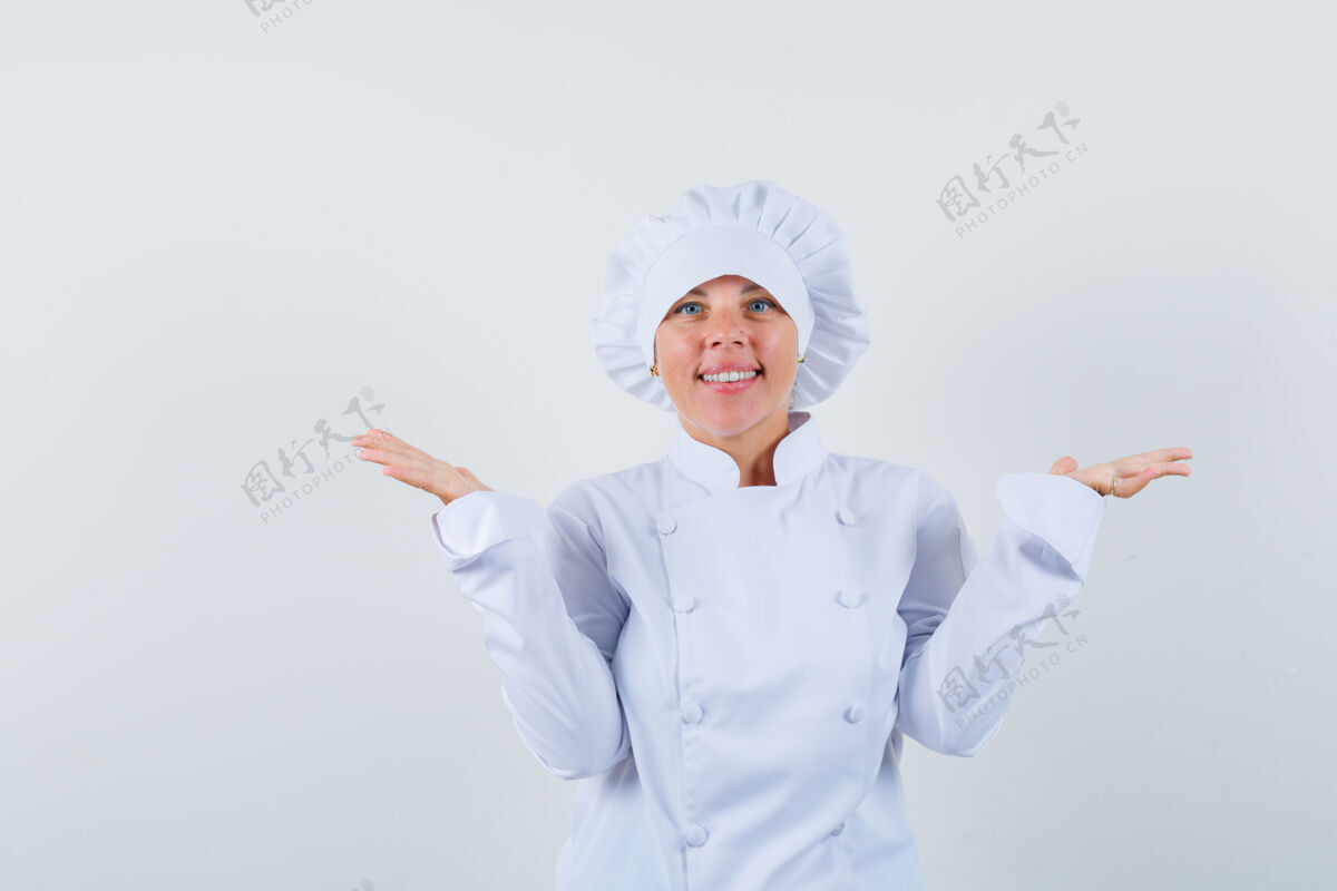 学生女厨师假装拿着或展示白色制服的东西 看起来很自信抱着女人可爱