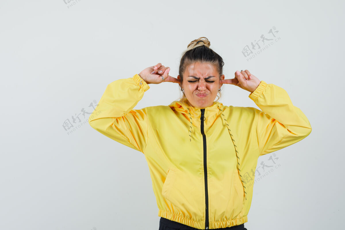 年轻人女性穿着运动服用手指堵住耳朵 看起来很恼火 正面图疾病堵塞面罩
