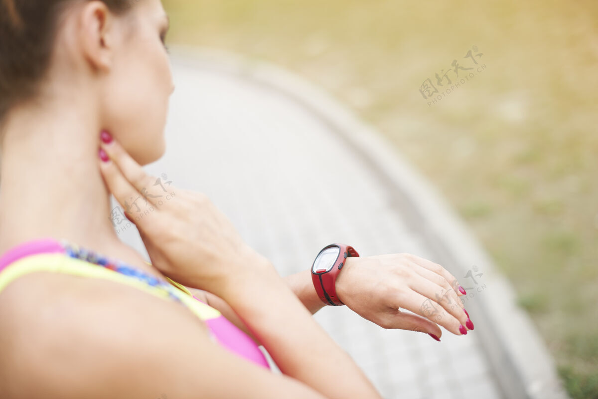 运动胸罩检查脉搏计的女人夏天转身放松