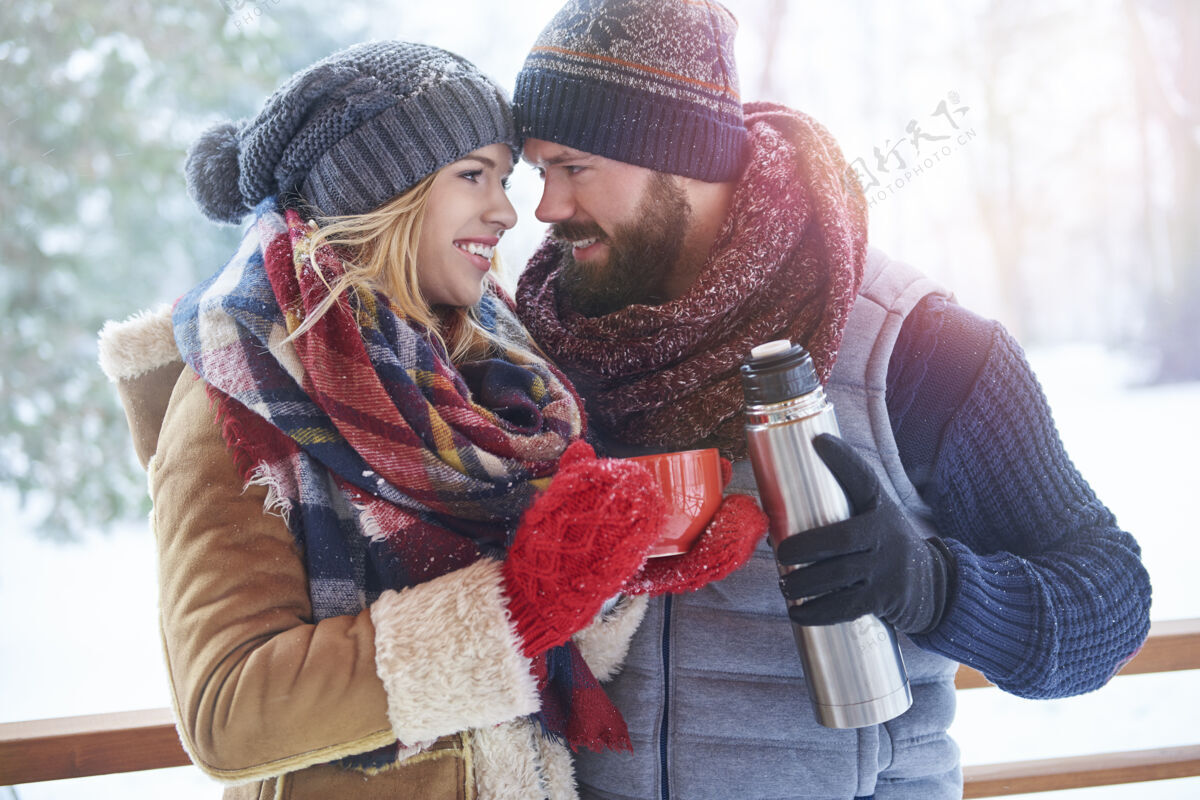 调情一杯热气腾腾的咖啡在冬天的景色雪热水瓶帽子