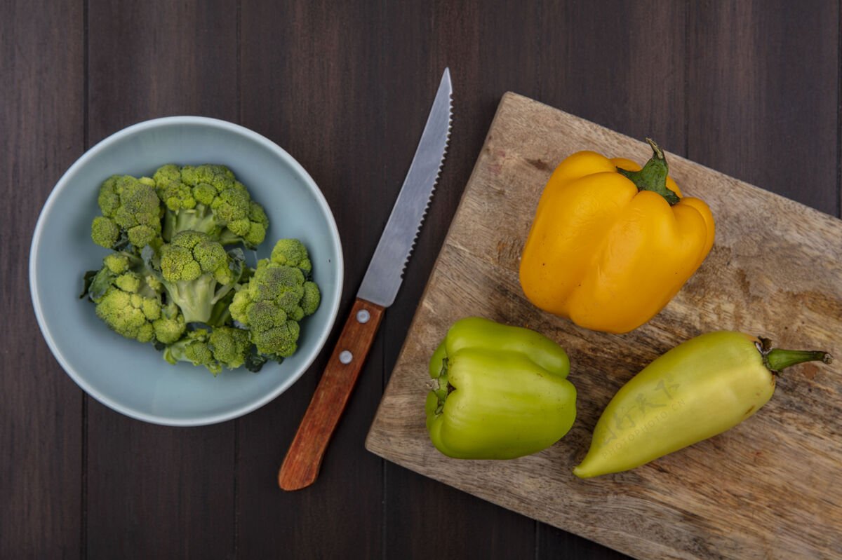 食物顶视图复制空间青椒和刀在木制背景的砧板碗花椰菜碗顶部副本