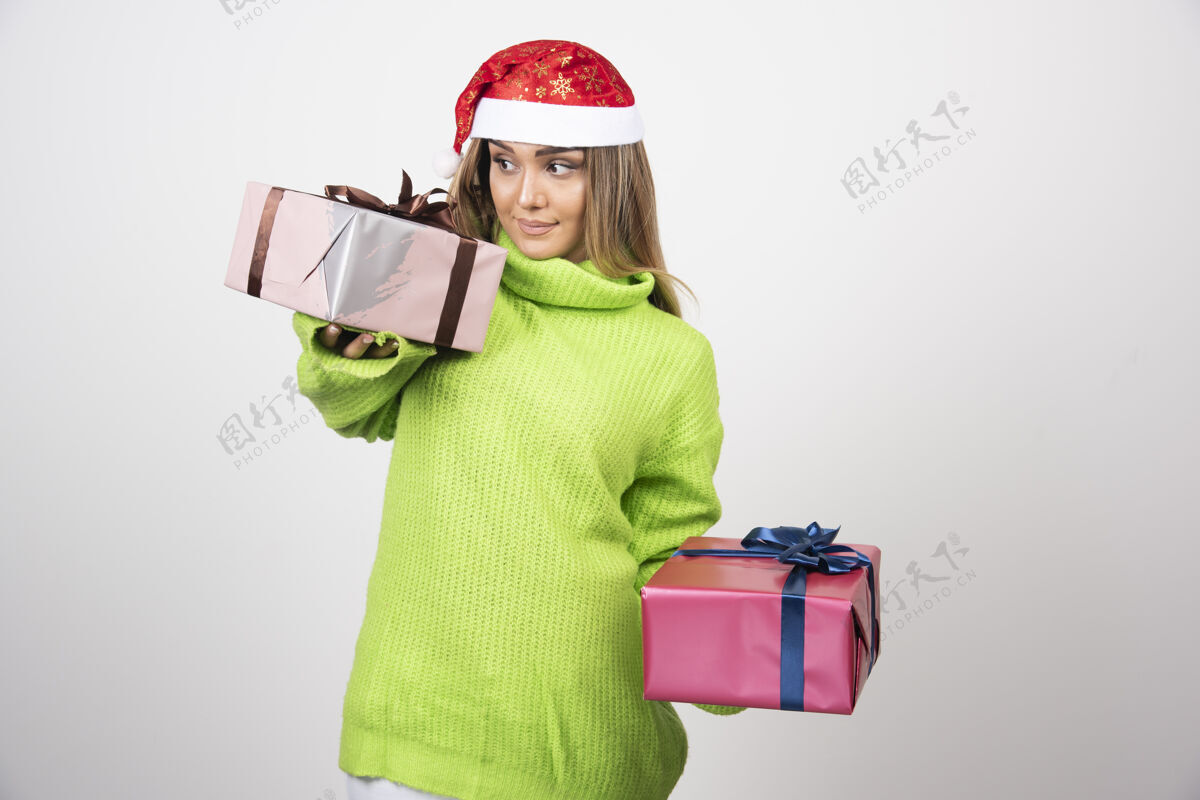 女孩手持圣诞礼物的年轻女子美丽人圣诞老人