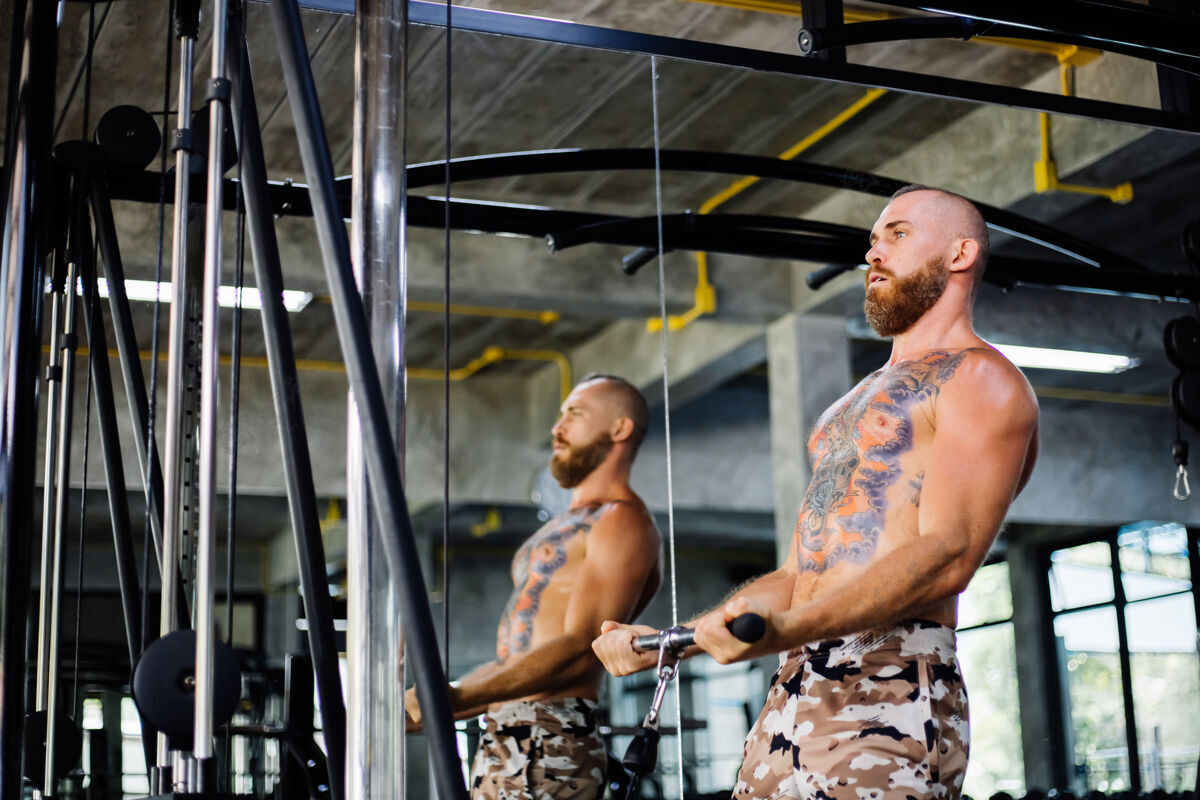力量纹身的健康男人在健身房锻炼教练健康肌肉